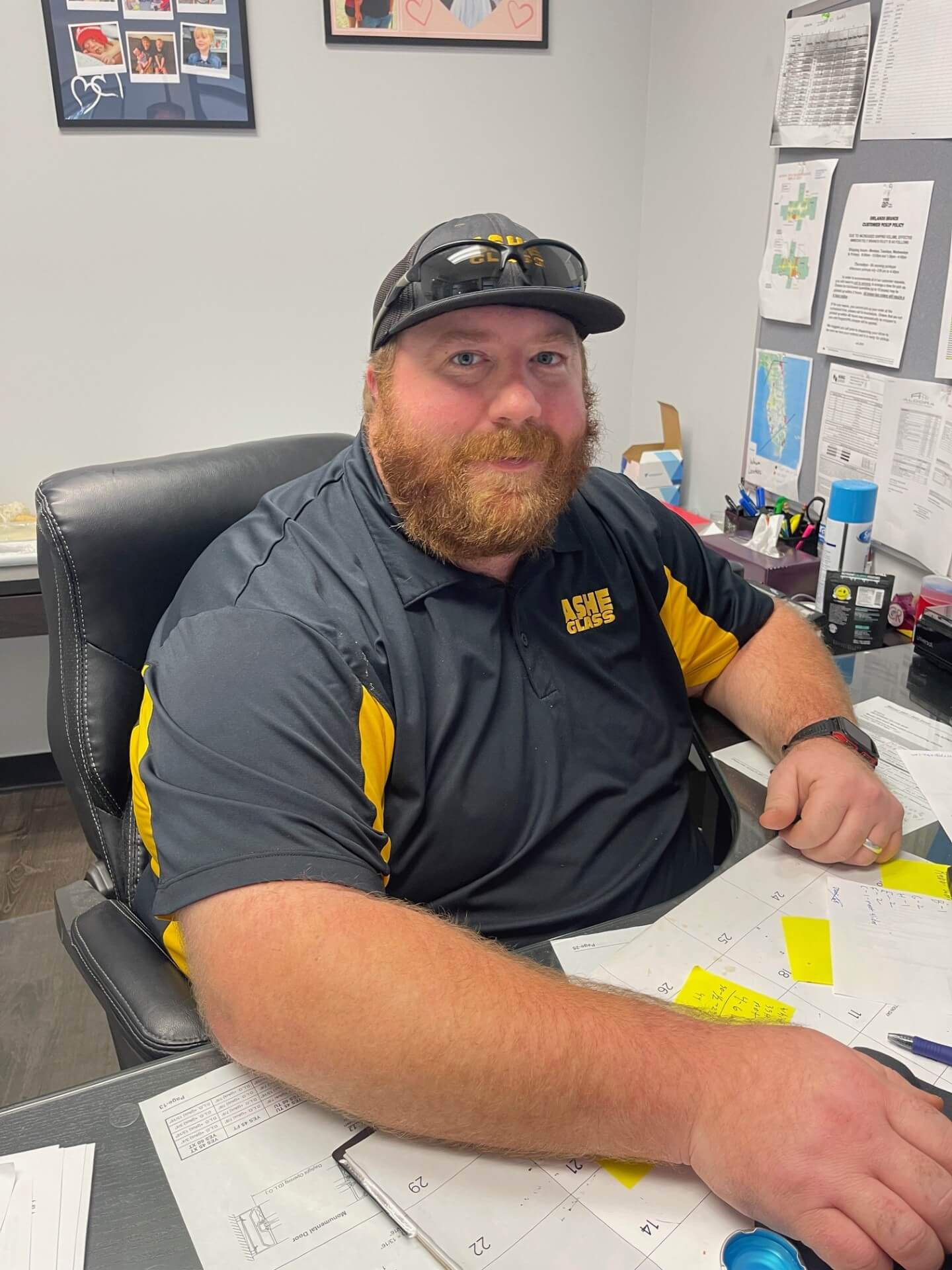 Bearded man reviewing documents at office desk