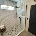 Modern subway-tile shower with hexagon floor