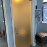 Frosted glass shower door with towel rack