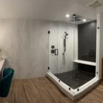 Glass shower and vanity near shower in modern bathroom