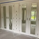 White built-in wardrobe with mirrored doors