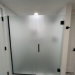 Frosted glass shower doors with black handle
