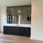 Modern wet bar with hanging glass shelves