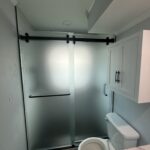 Bathroom with frosted glass sliding shower door