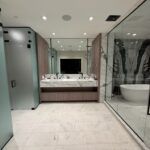 Modern marble bathroom with double sinks and tub