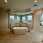 Freestanding bathtub centered in modern bathroom