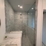 Marble bathroom with glass-enclosed shower