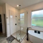 White modern bathroom with glass shower and tub