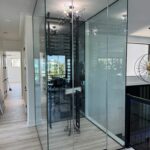 Glass-enclosed wine cellar with chandelier