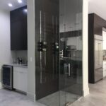 Glass-enclosed wine cellar in modern kitchen