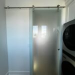 Frosted glass sliding door on metal track