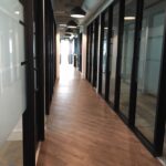 Modern office hallway with glass partitions