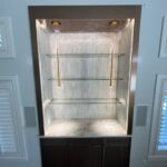 Illuminated recessed shelves with marble countertop