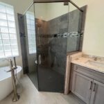 Glass corner shower with bathtub and vanity