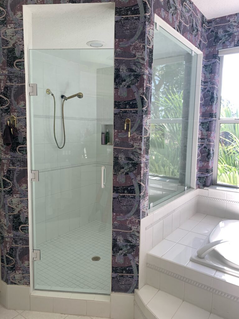Glass shower and bathtub in tiled bathroom