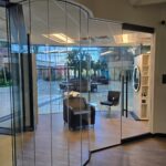 Glass walled hair salon with chairs and sink
