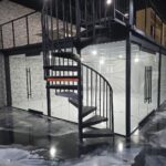 Black spiral staircase in modern glass office