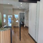 Glass office door reflecting reception area