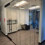 Glass-walled salon room with wash basin